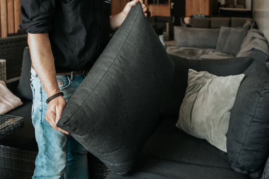 Kussens worden geschikt op een loungeset in de showroom